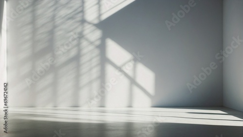 Empty room with grey walls and light shadow from the window  seen from the front. Modern minimalist background for product presentation or display