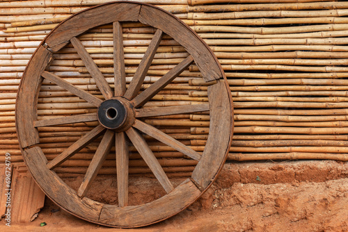 A wheel of a bullock cart just outside of beautiful traditional tribal bamboo cottage or hut at Kanger valley national park, Chattisgarh, India. © Rima