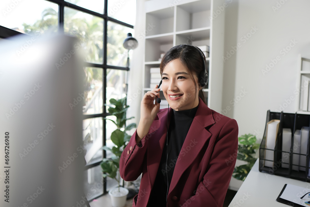 Portrait of a cheerful young woman working as a call center operator, wearing headphones and holding a microphone. Portrait of a cheerful young woman working as a call center operator, wearing headphones and holding a microphone.