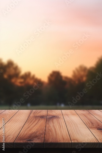 A wooden table with a beautiful and hazy sunset in the background. Perfect for adding a warm and rustic touch to any design or project