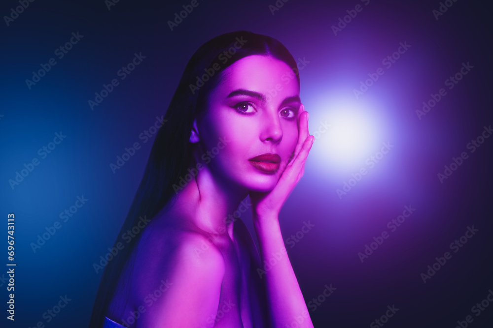 Fototapeta premium Portrait of beautiful woman in neon lights