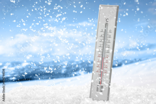 Weather thermometer under falling snow outdoors on winter day, space for text photo