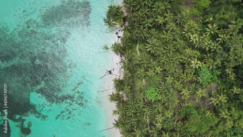 Orbit shot of Zapatilla Cay in Bocas del Toro, Panama_4K. Beach with palm trees photo