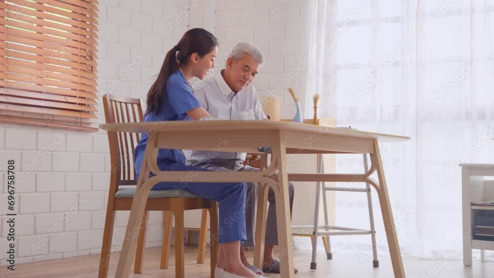 Asian young caregiver nurse examine senior older man patient at home. Asian young caregiver nurse examine senior older man patient at home.