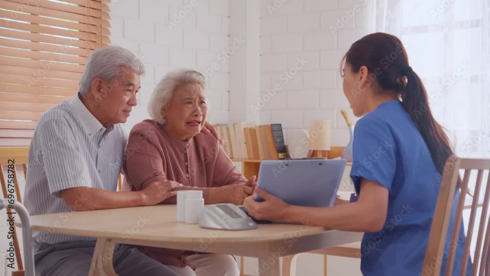 Asian caregiver examine depress senior crying woman patient and husband. 