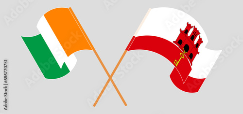 Crossed and waving flags of Ivory Coast and Gibraltar photo