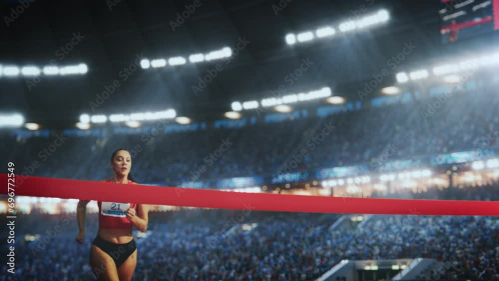 Cinematic Slow Motion Footage of a Runner with Speed Ramp Effect. Strong Female Athlete is Sprinting Towards the Line in a Crowded Stadium, Crossing the Race Finish with Her Hands in the Air