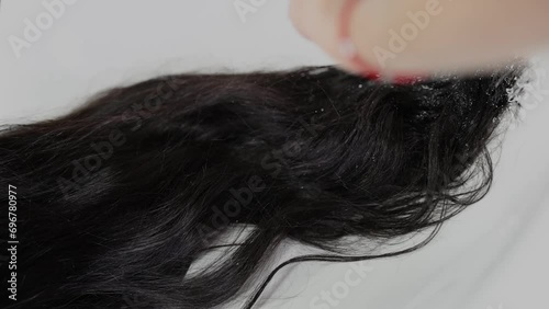 a girl with black hair is washed before the procedure in a beauty studio