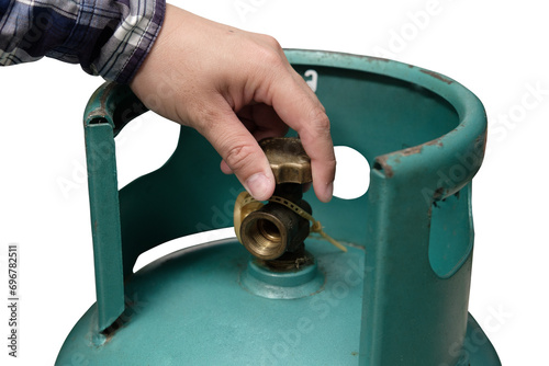 Male hand is closing the valve of lpg gas tank for safety. Files can use clipping parts.