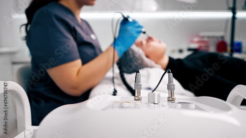 a beautician doctor massaging the skin of a client's face during a beauty and health cosmetic procedure photo