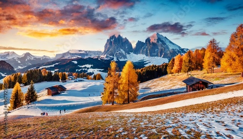 captivating sunset in alpe di siusi ski resort with beautiful yellow larch treeforest unbelievable autumn view of schlern sciliar peak dolomite alps ortisei locattion italy photo
