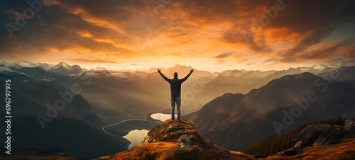Man with arms up celebrating on top of the mountains - Hiker enjoying freedom on a hill at sunset - Freedom, sport, success and mental health concept © Lucky Ai