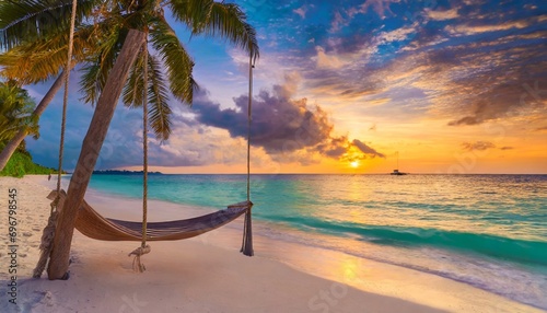 tropical sunset beach and sky background as exotic summer landscape with beach swing or hammock and white sand and calm sea beach banner paradise island beach vacation or summer holiday destination