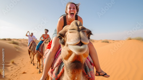 Happy Woman riding camel in sand desert © PaulShlykov