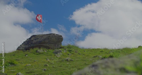 Swiss flag flying on the mountain top