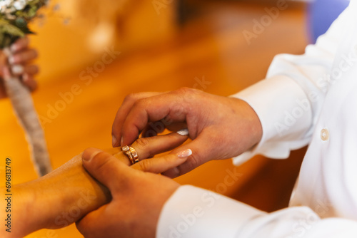 Man putting the ring on the bride at a wedding  marriage ceremony