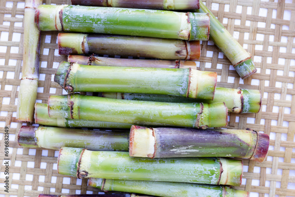 Fototapeta premium Fresh sugar cane on bamboo weave plate