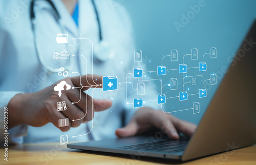 A medical worker works with electronic database and documents.Technology and access information, database, storage, Digital link tech, big data