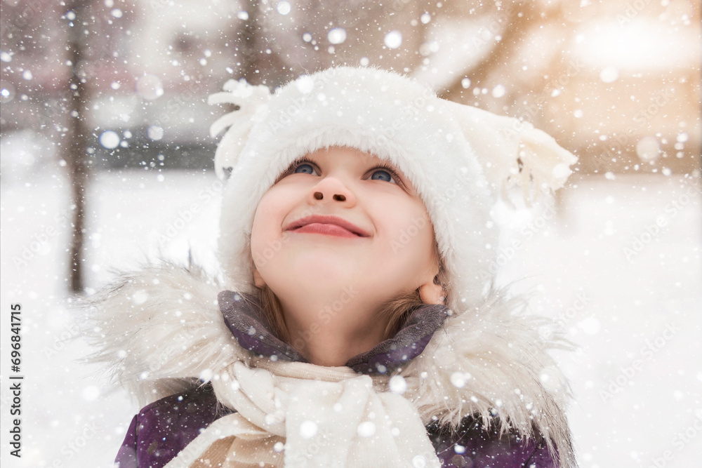 Winter Children Holidays. Happy Child Little Girl Enjoying Snow Falling in Winter Snowy Park. Kid Likes Snowflakes Fall Winter Children Holidays. Happy Child Little Girl Enjoying Snow Falling in Winter Snowy Park. Kid Likes Snowflakes Fall