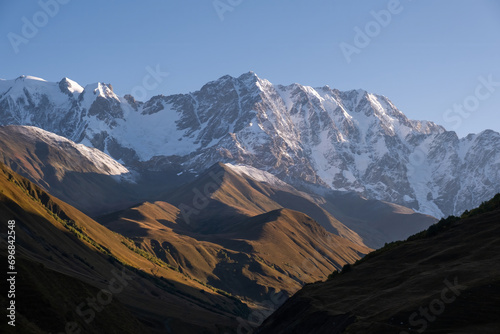 View of the mountain valley, Mount Shkhara at sunrise.