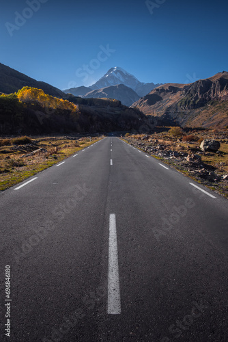 road going towards the mountains, Mount Kazbek in autumn