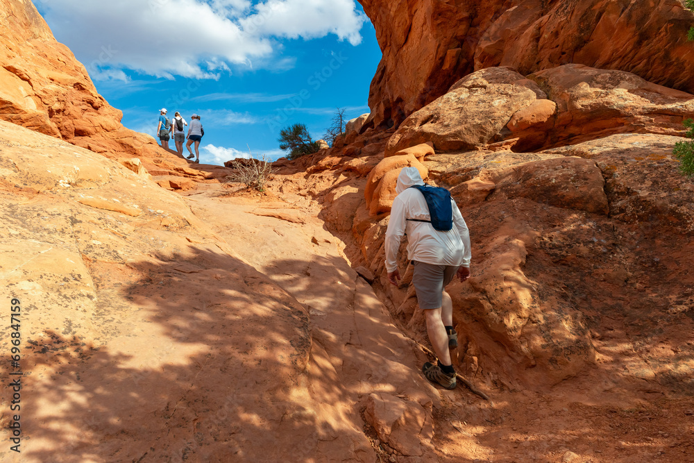 Man Hiking Red Mountains in Arches NP, Moab, Utah
