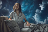 A young beautiful woman in pajamas with closed eyes in bed against the magic background of clouds. Cozy night atmosphere