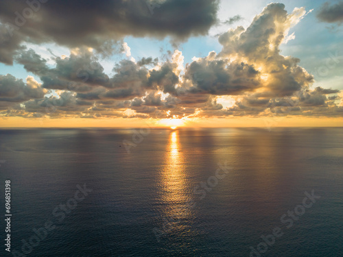 Drone shot of a cloudy sunset over the sea
