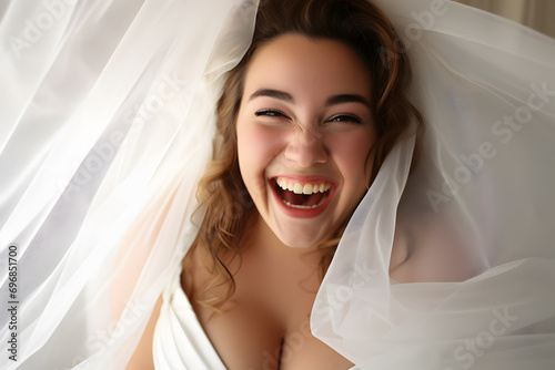 Laughing pretty curvy plus size bride in wedding dress