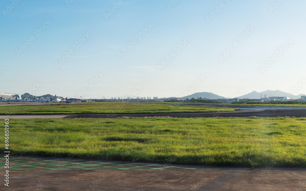 Empty airport runway under blue sky