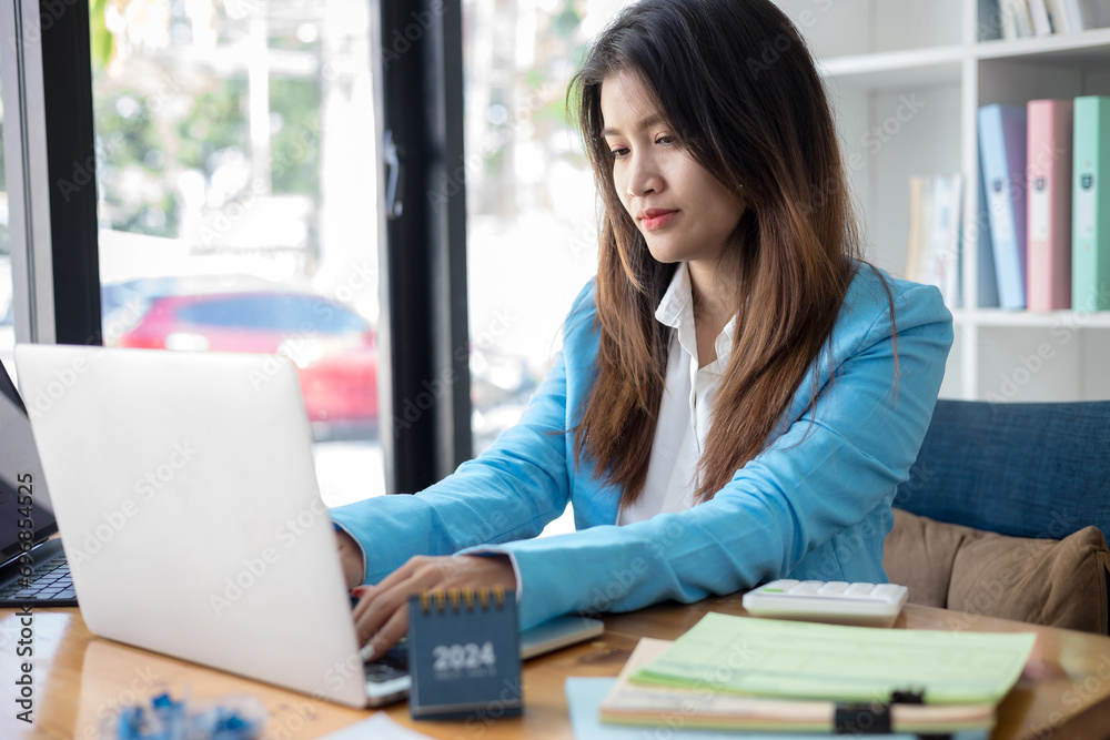 Business woman working in office with documents and laptop. Business concept Business woman working in office with documents and laptop. Business concept