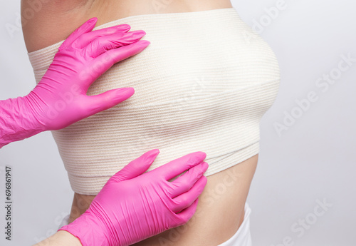 Bandage on a woman's chest. Breast augmentation. Silicone breast photo