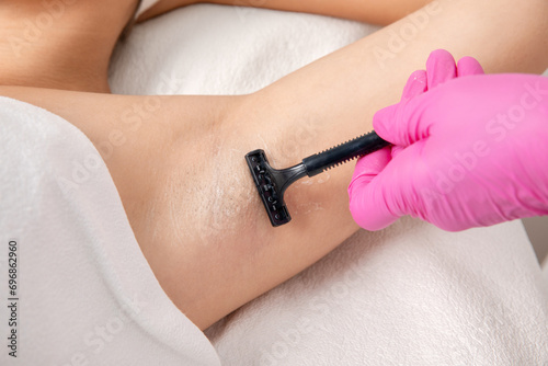 Elos epilation hair removal procedure on a woman’s body. Beautician doing laser rejuvenation in a beauty salon. Removing unwanted body hair. Hardware ipl cosmetology