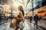 Young woman with shopping bags in a shopping passage