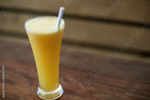 A Glass of Orange Juice with a Straw