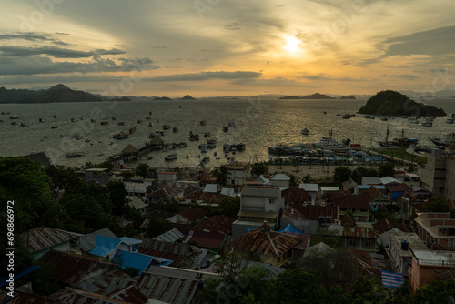 General view of Labuan Bajo Town from Puncak Waringin with the background of port during sunset. photo