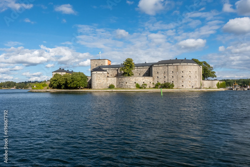 Photography Historic Vaxholm Fortress on a sunny autumn day, surrounded by calm waters and blue sky