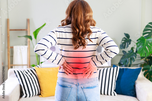 Young woman suffering from lower back pain