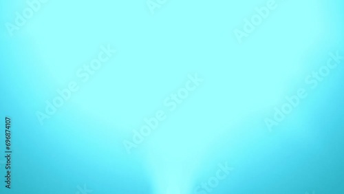 Glittering particles with lens flare on a black background in slow motion, dynamic wind particles in the air with bokeh.