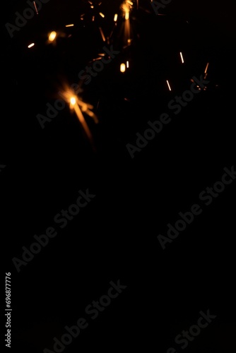 Perfect fire particles embers sparks on black background . Texture overlays.