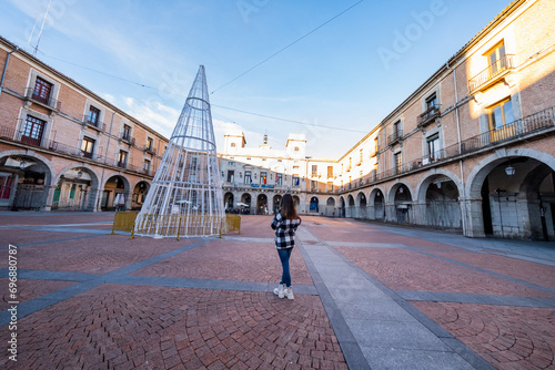 Caucasian woman explores Avila's winter charm. photo