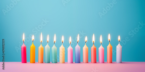 colorful burning candles with flame in a row - theme birthday, celebration or children's birthday party