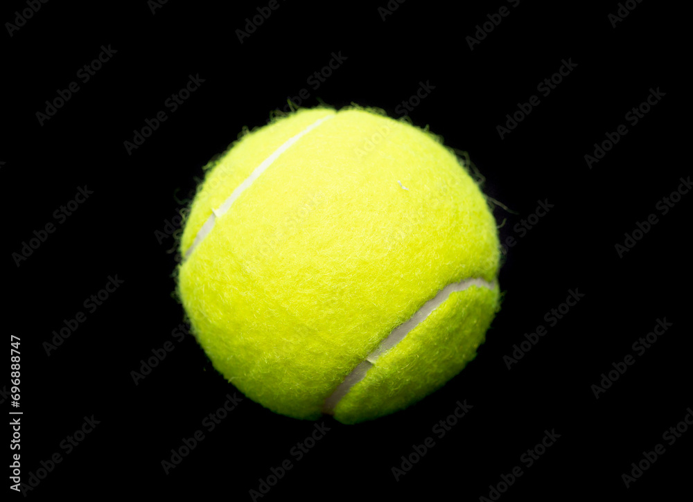 Yellow tennis ball on a black background.
