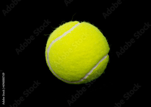 Yellow tennis ball on a black background. © Prikhodko