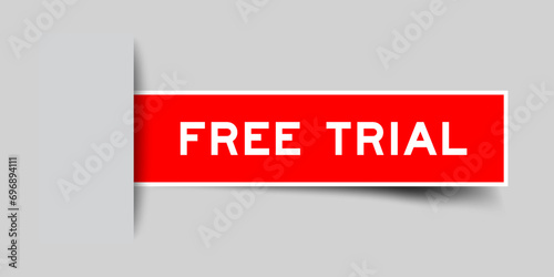 Red color square label sticker with word free trial that inserted in gray background