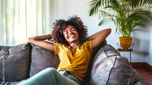 black woman relaxing on the couch at home