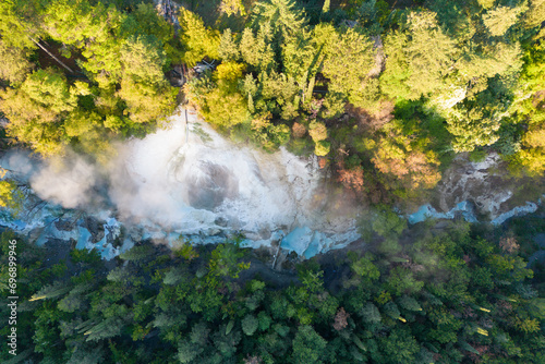 Aerial drone view of a hotspring in the forest of Italy