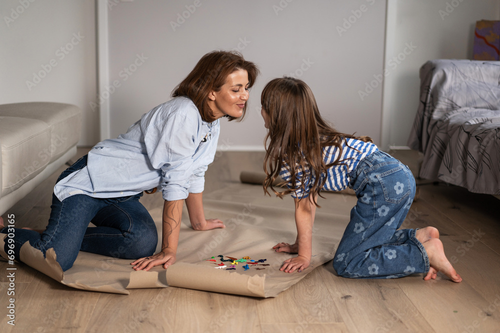 Mother and daughter at home are engaged in drawing Mother and daughter at home are engaged in drawing