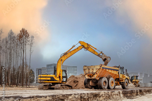 View a digger and dumper truck on a brownfield site in the construction industry. Construction equipment.