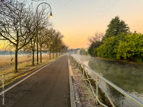 Cycle path along the Naviglio in Milan at dawn.